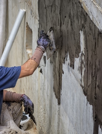 Applying Sealer coat to basement foundations